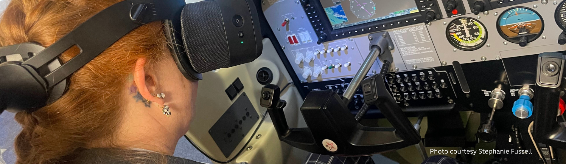 Woman using virtual reality goggles in aircraft cockpit